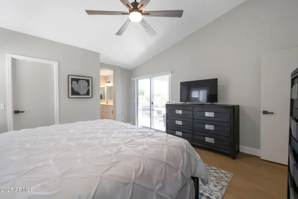 a bedroom with a bed and a television