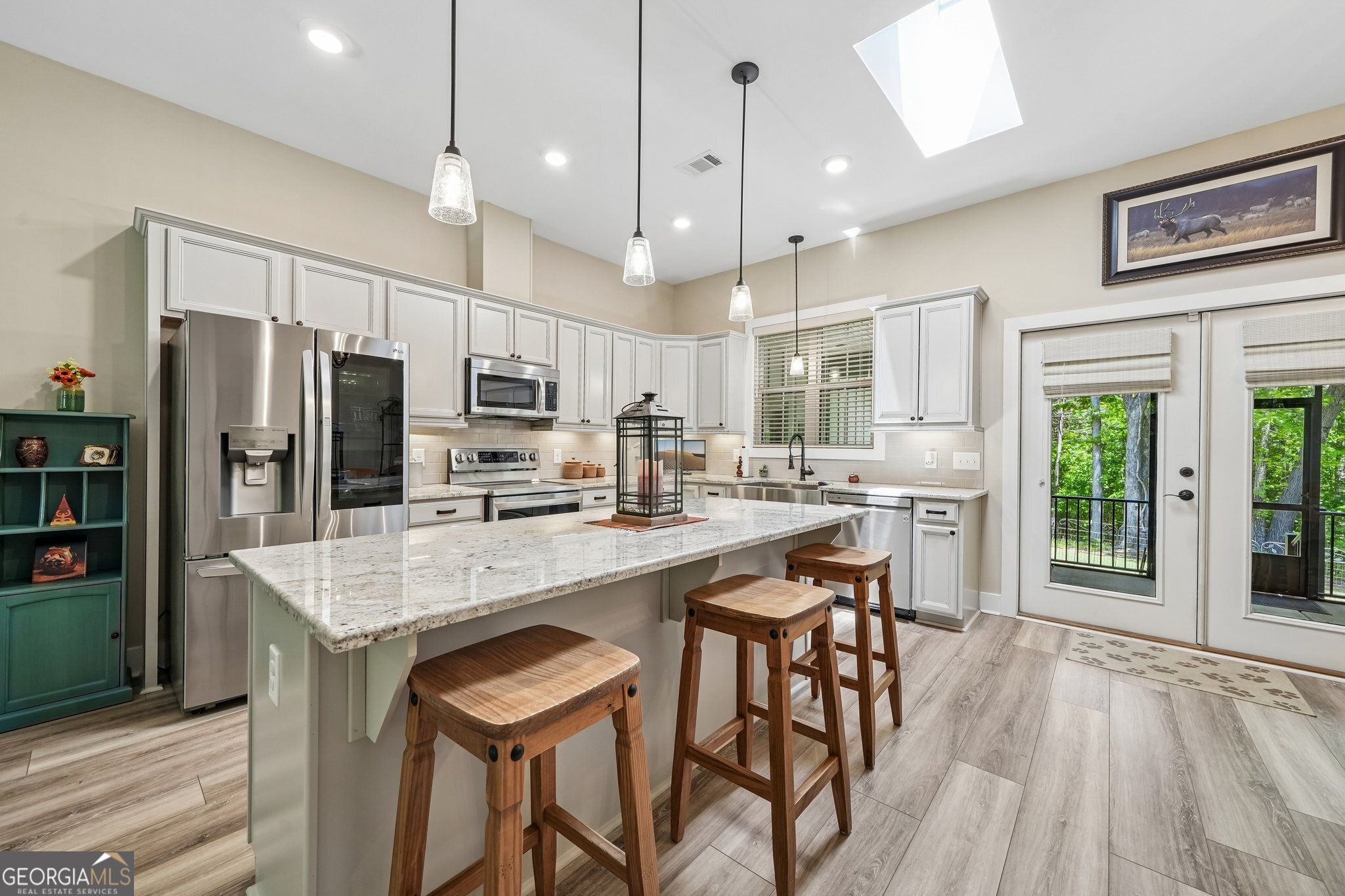 108 Wilderness Way Jackson, GA 30233 - Photo 13 of 31 a kitchen with stainless steel appliances granite countertop a stove refrigerator and chairs with wooden floor