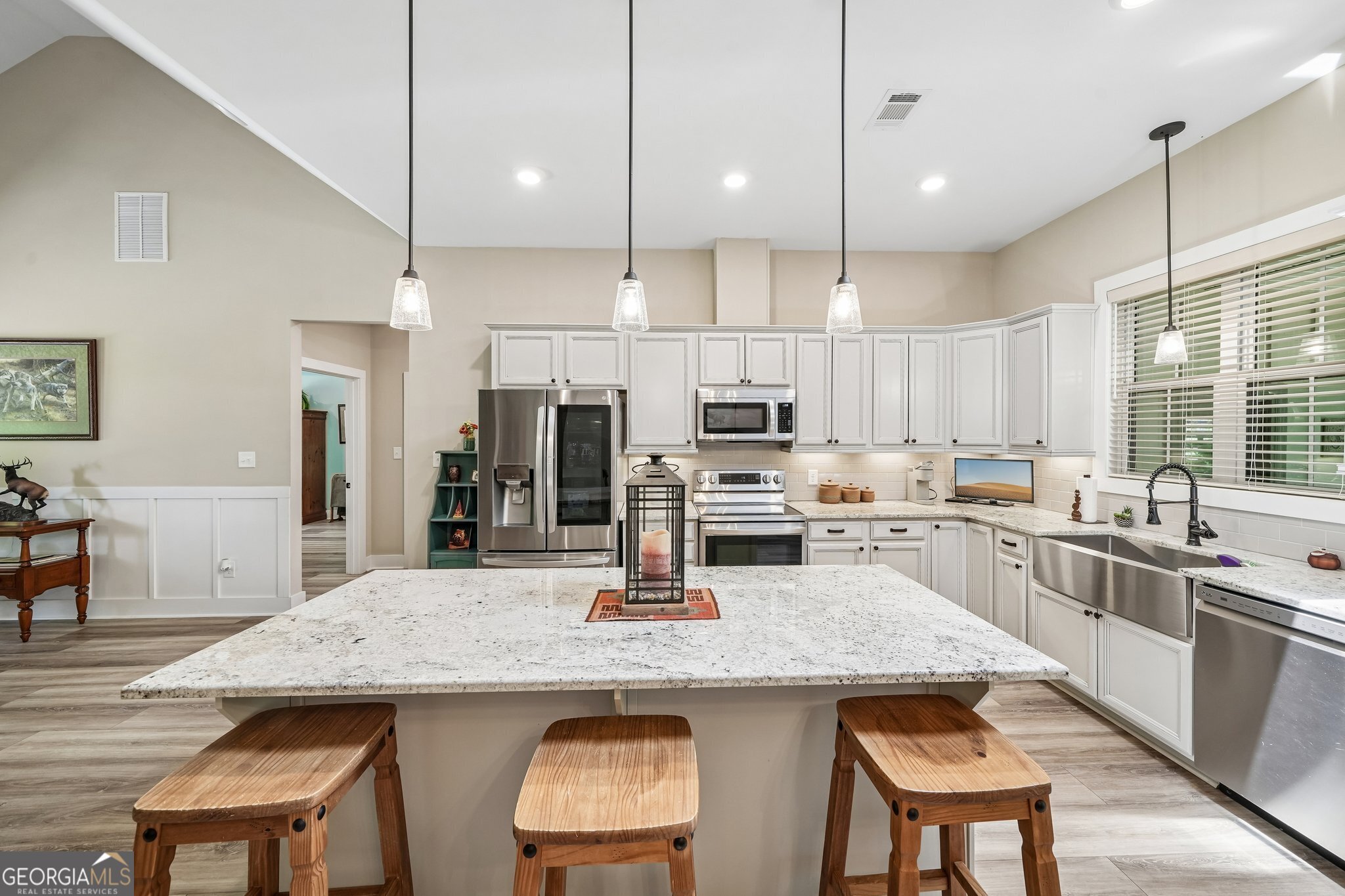 108 Wilderness Way Jackson, GA 30233 - Photo 14 of 31 a kitchen with stainless steel appliances kitchen island granite countertop a kitchen island and chairs in it