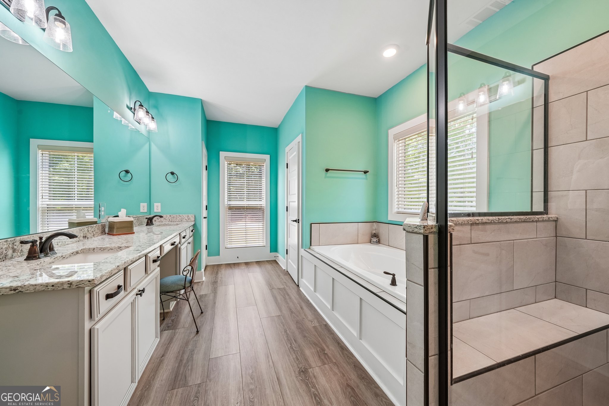 108 Wilderness Way Jackson, GA 30233 - Photo 19 of 31 a spacious bathroom with a granite countertop tub double vanity sink a mirror and a shower