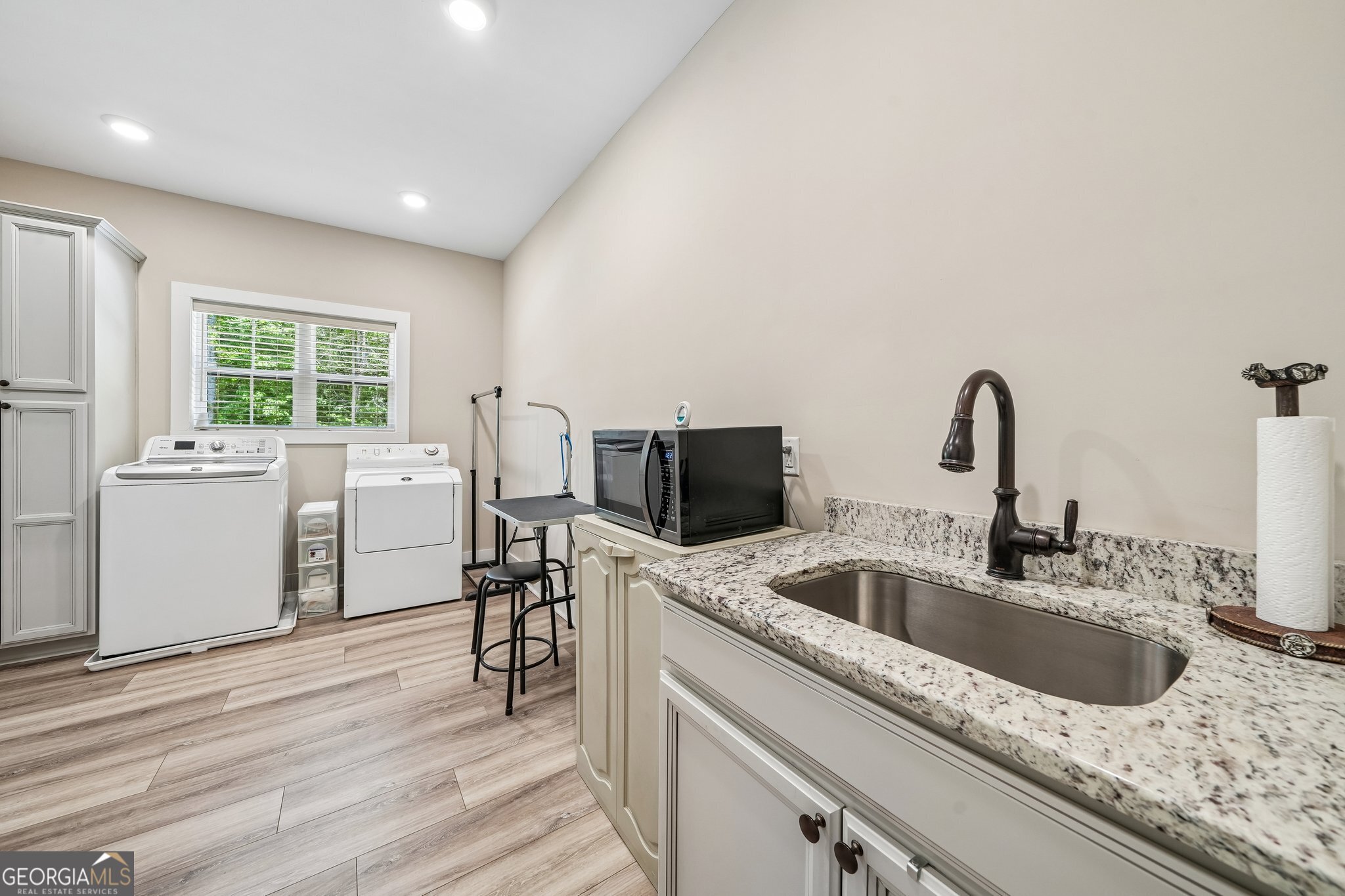108 Wilderness Way Jackson, GA 30233 - Photo 21 of 31 a kitchen with stainless steel appliances granite countertop a sink and dishwasher with wooden floor