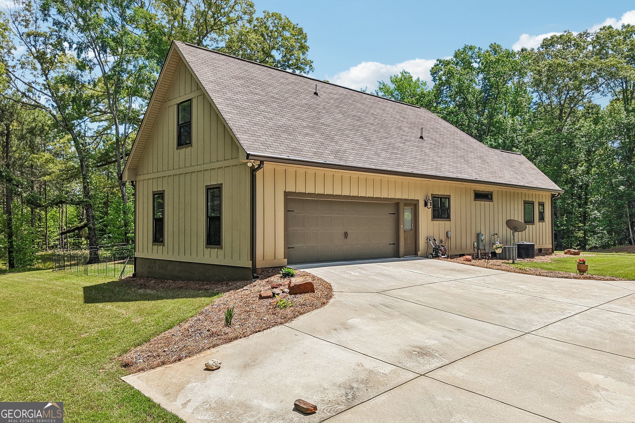 108 Wilderness Way Jackson, GA 30233 - Photo 4 of 31 a front view of a house with a yard and garage