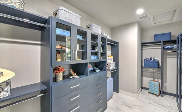 a kitchen with stainless steel appliances granite countertop a refrigerator and a wooden floor