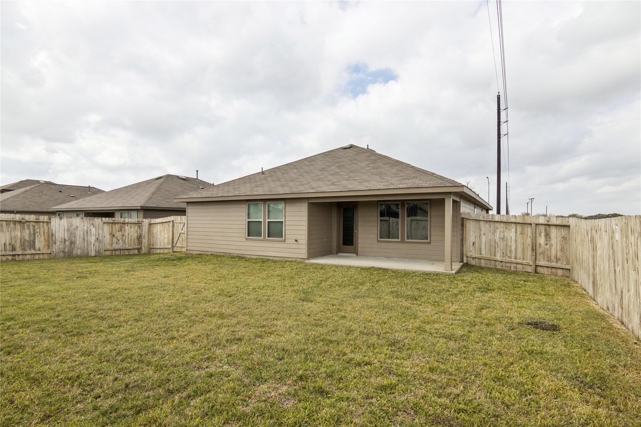 1603 Goose Island Lane Rosenberg, TX 77469 - Photo 25 of 26 a white house with a big yard and a fountain