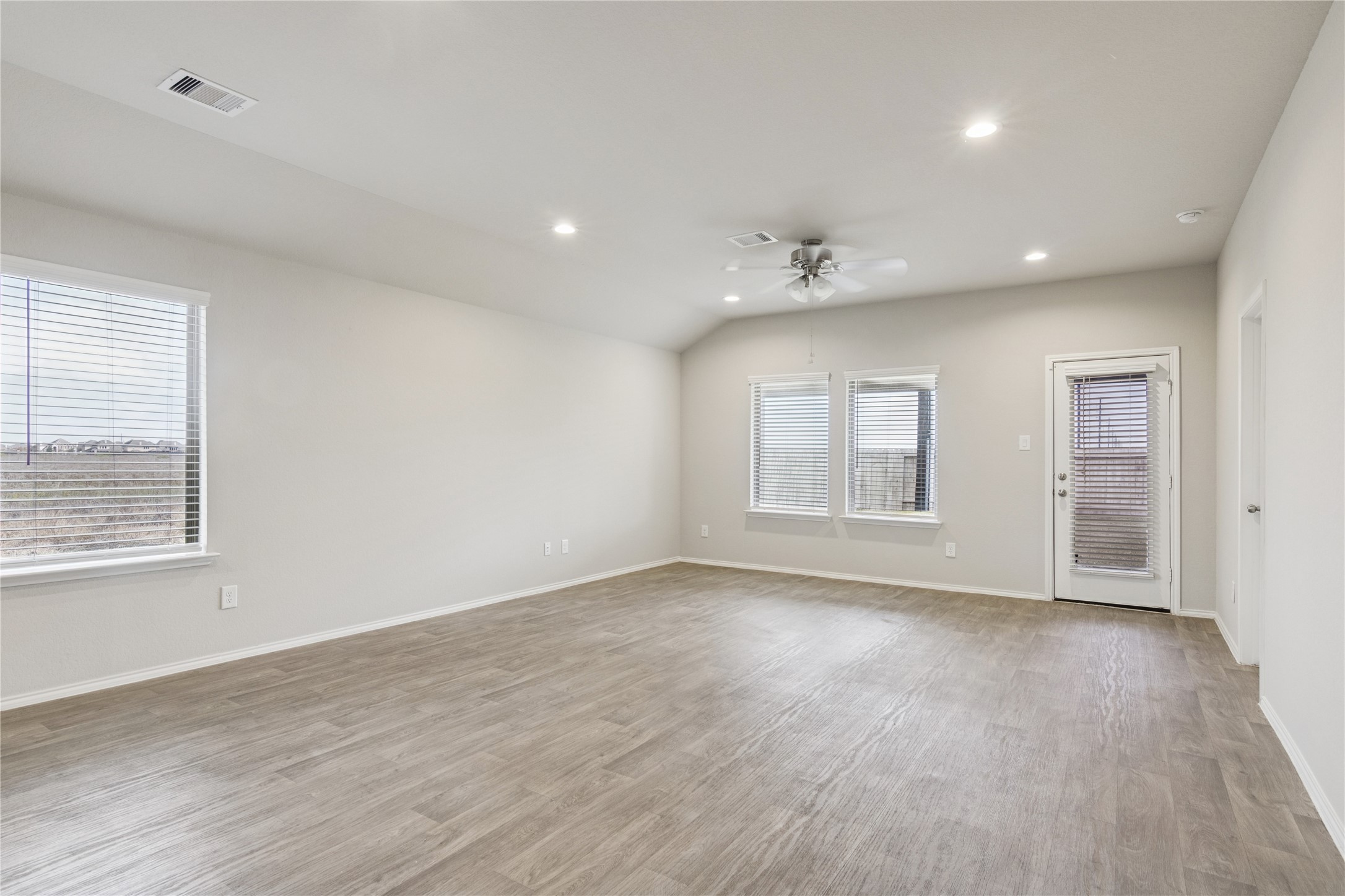 1603 Goose Island Lane Rosenberg, TX 77469 - Photo 7 of 26 an empty room with wooden floor and windows