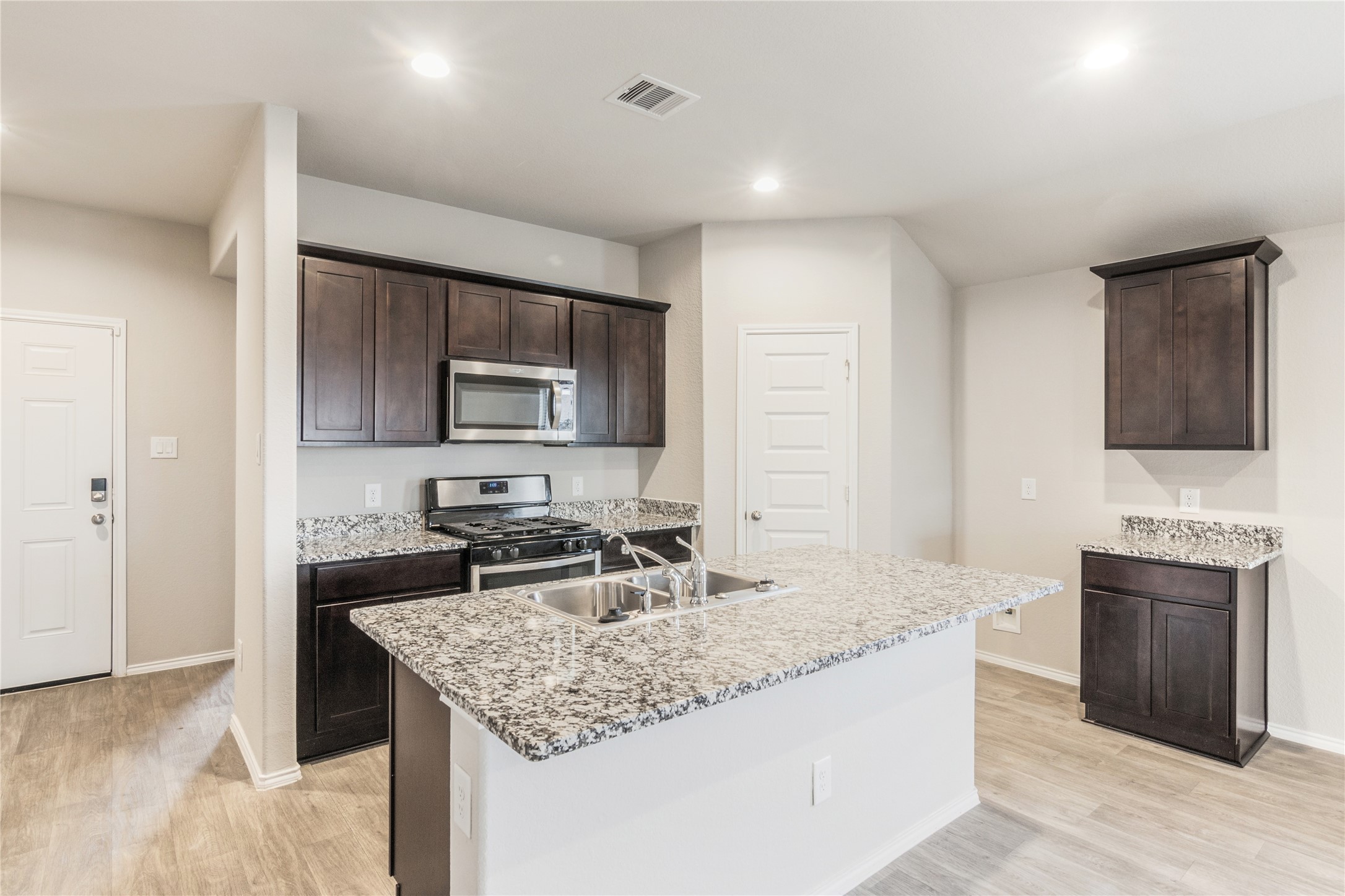 1603 Goose Island Lane Rosenberg, TX 77469 - Photo 10 of 26 a kitchen with a sink stove and cabinets