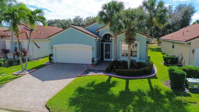an aerial view of a house with a yard and plants