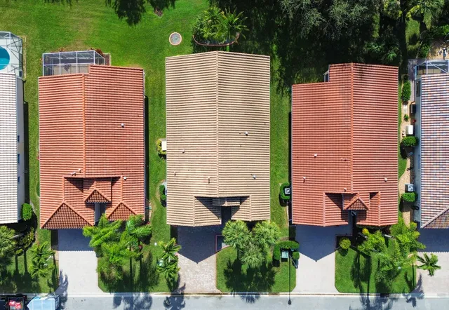 an aerial view of residential houses with outdoor space and street view