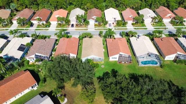 an aerial view of multiple houses with yard