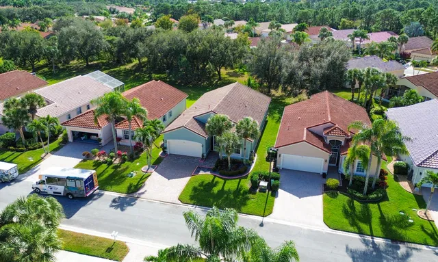 a house with a big yard and palm trees