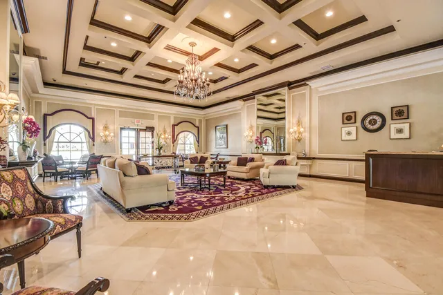 a living room with a couch and a chandelier