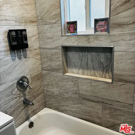 a bathroom with a toilet and a mirror