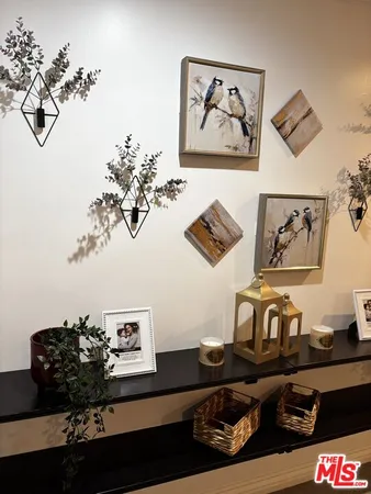 a living room with furniture and painting on the wall