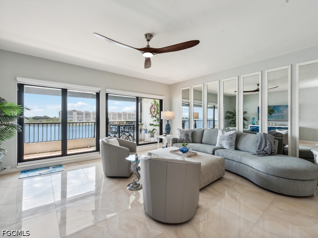 232 La Peninsula Boulevard, Unit 232 Naples, FL 34113 - Photo 13 of 44 a living room with furniture and a large window
