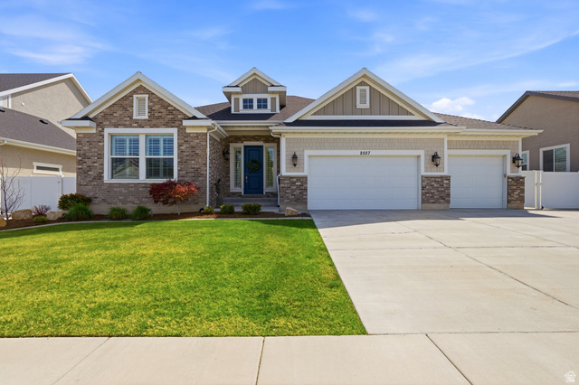 2557 Midas Side Way Riverton, UT 84065 - Photo 1 of 1 Craftsman-style home with a garage, driveway, board and batten siding, and brick siding