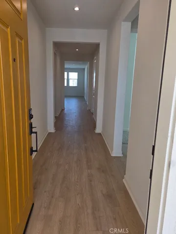 a view of a hallway with wooden floor