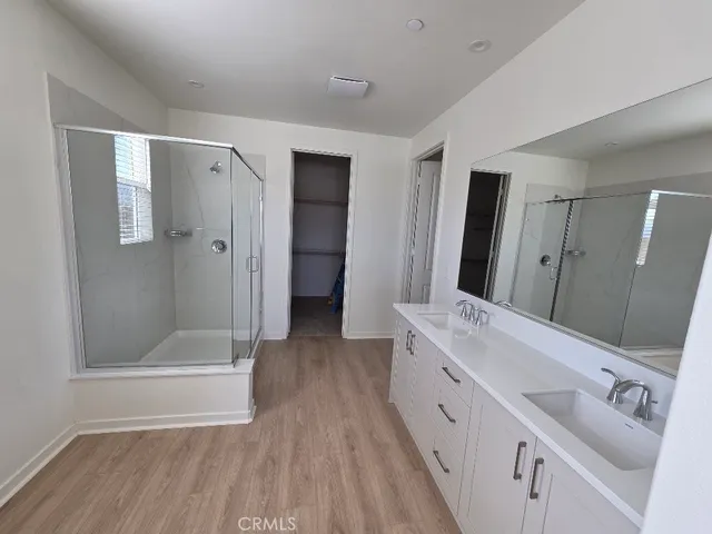 a bathroom with a double vanity sink and a mirror