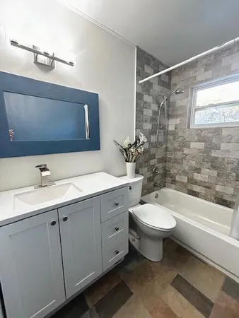 a bathroom with a toilet sink and mirror