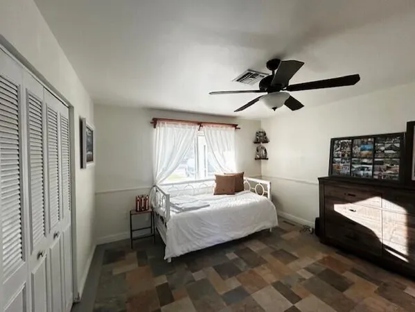 a bedroom with a bed and window