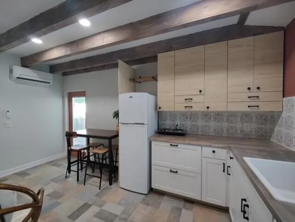 a large white kitchen with a large window