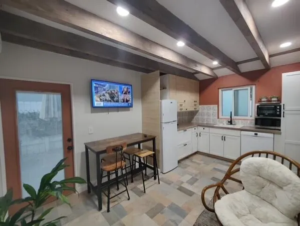 a kitchen with granite countertop stainless steel appliances a sink and cabinets