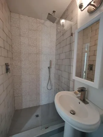 a bathroom with a toilet sink and shower