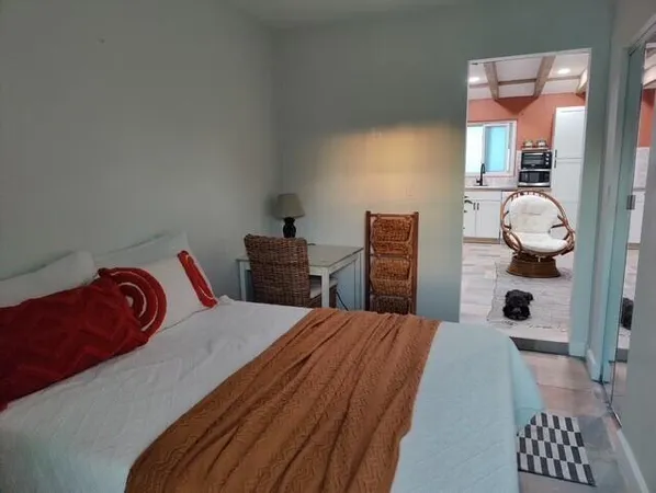 a bedroom with a bed and a night stand