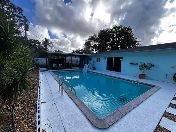 a view of a swimming pool with an outdoor seating