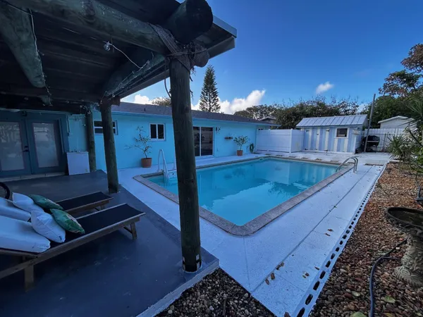 a view of a swimming pool with a yard