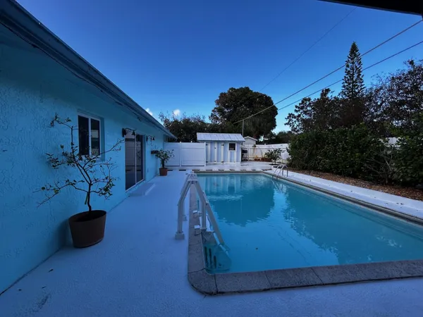 a building outdoor space with patio furniture and potted plants