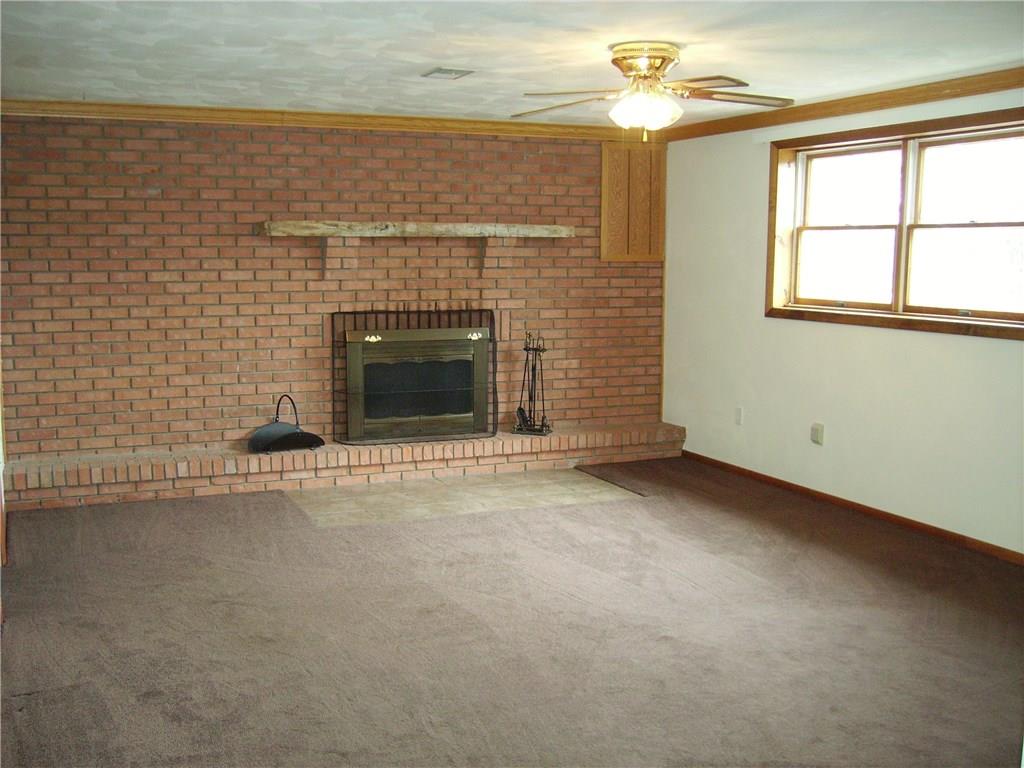 110 Parker Road Sarver, PA 16055 - Photo 11 of 17 Gameroom with woodburning fireplace featuares full brick wall.