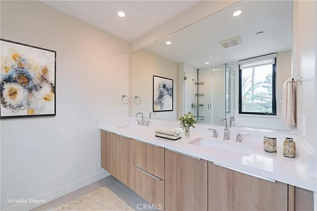 a spacious bathroom with a double vanity sink and a mirror