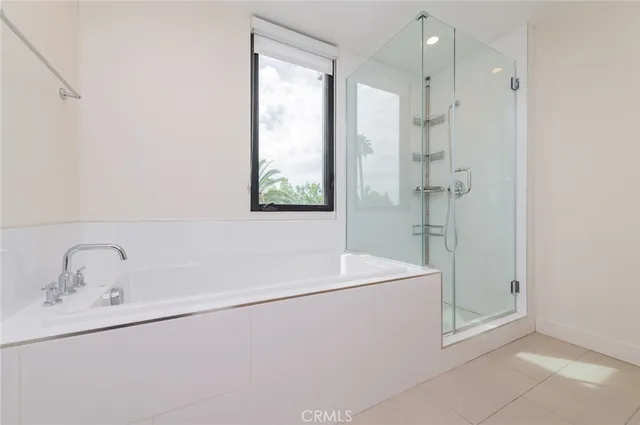 a bathroom with a sink a window and a shower