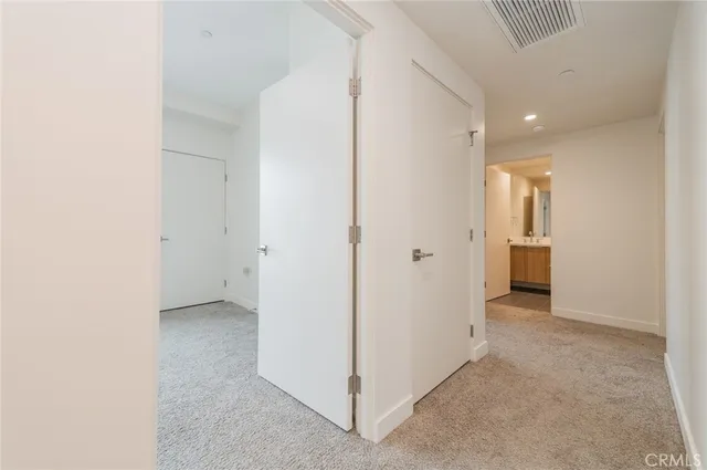 a view of a hallway with wooden shelves