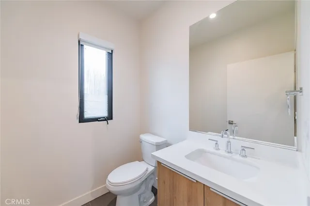 a bathroom with a sink toilet and a mirror