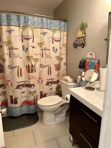 a white toilet sitting next to a bathroom sink