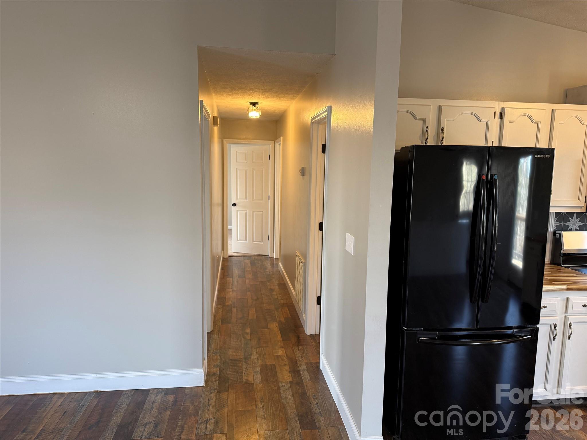 628 Hidden View Loop Marion, NC 28752 - Photo 13 of 44 a view of a hallway with wooden floor