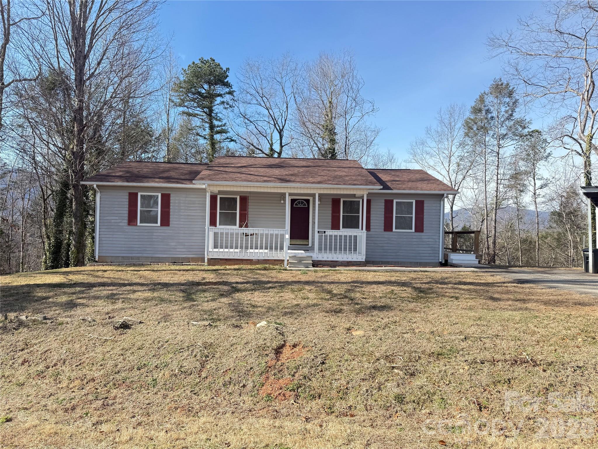 628 Hidden View Loop Marion, NC 28752 - Photo 2 of 44 a front view of a house with a garden