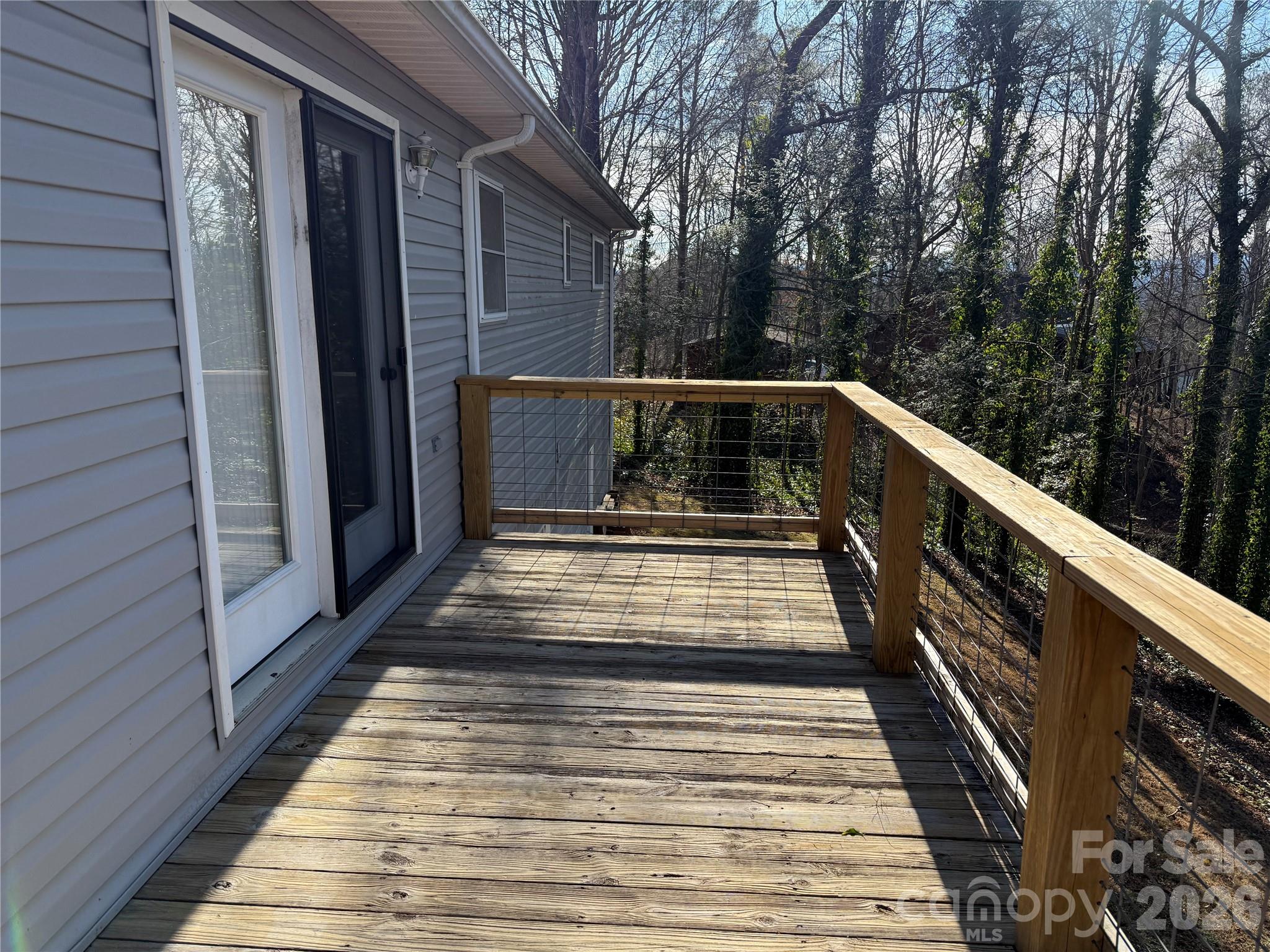 628 Hidden View Loop Marion, NC 28752 - Photo 25 of 44 a view of balcony with wooden floor and fence and a bench