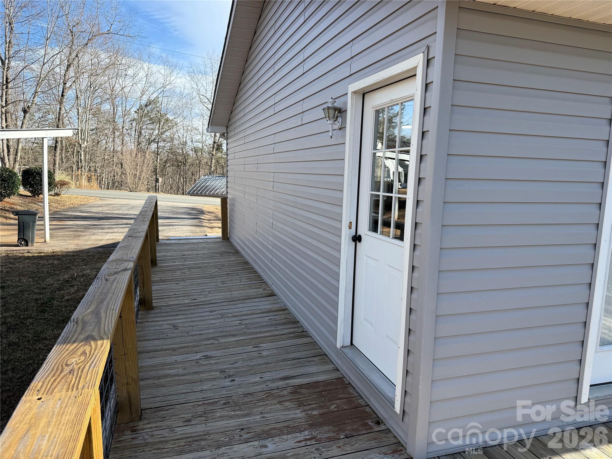 628 Hidden View Loop Marion, NC 28752 - Photo 26 of 44 a view of a balcony with wooden floor and fence and a floor to ceiling window