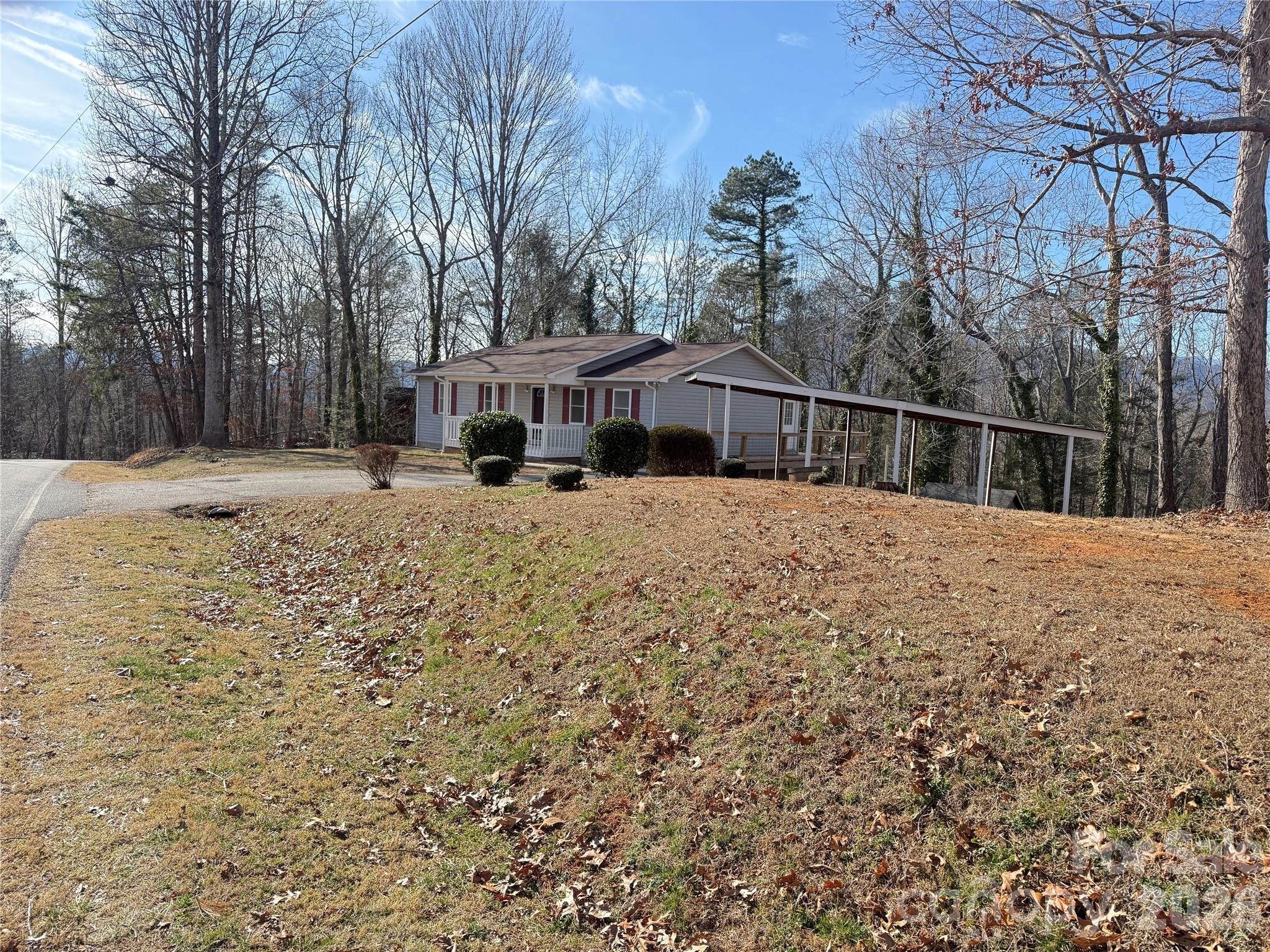 628 Hidden View Loop Marion, NC 28752 - Photo 4 of 44 a view of a house with a yard covered in snow