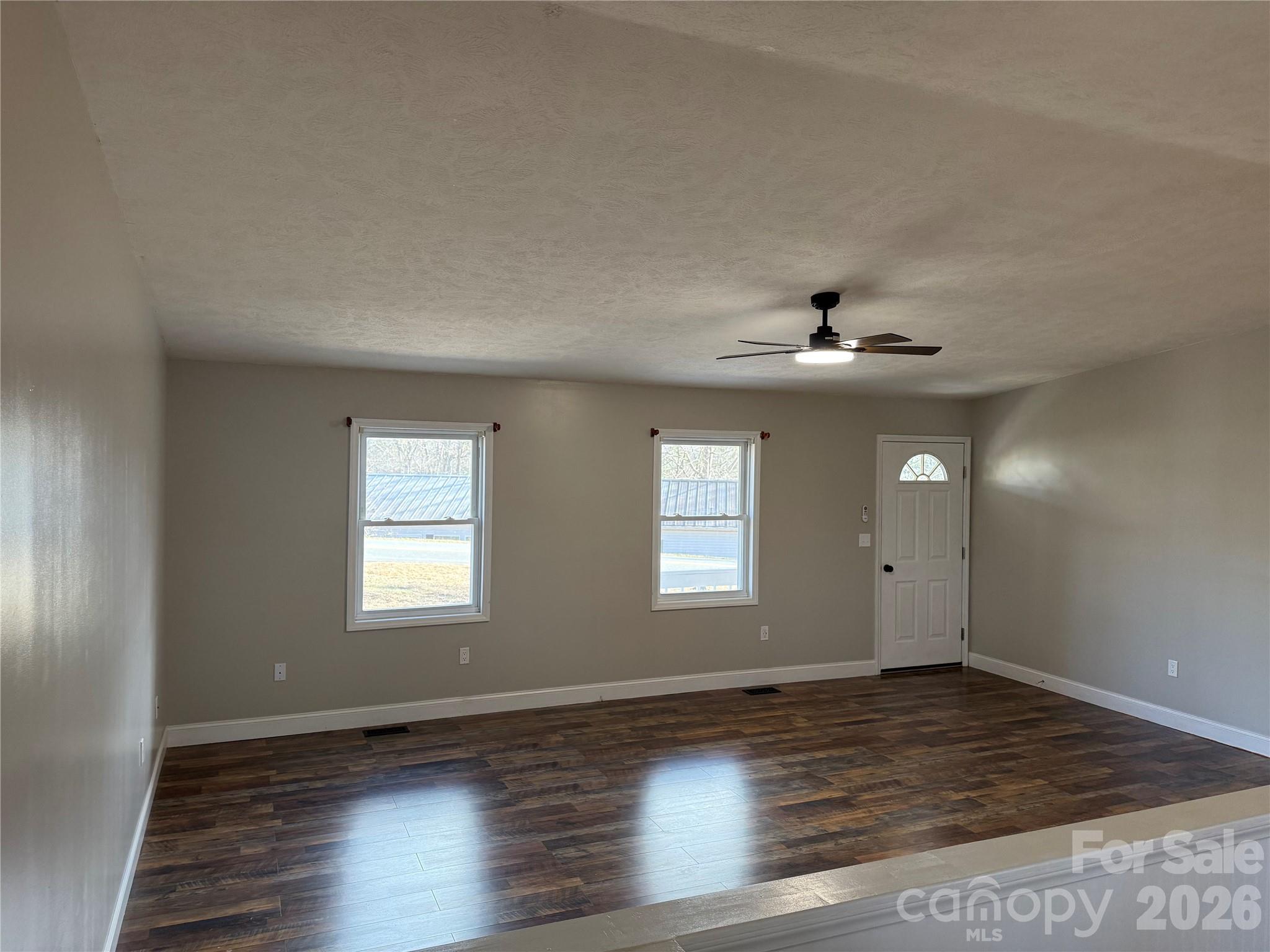 628 Hidden View Loop Marion, NC 28752 - Photo 10 of 44 a view of an empty room with wooden floor and a window