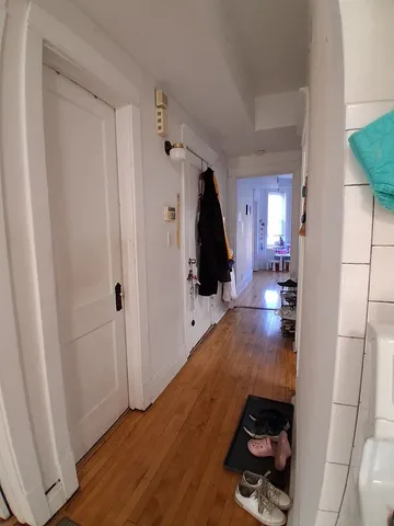 a view of hallway with wooden floor and stairs