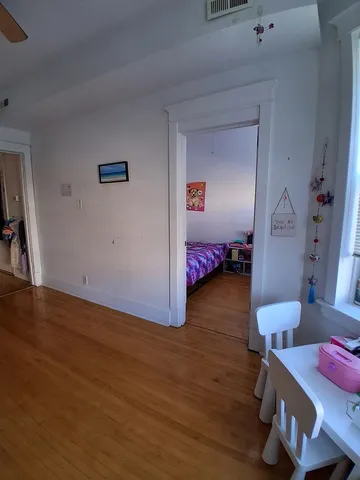 a bedroom with furniture and wooden floor