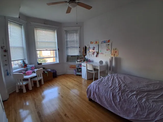 a bed room with a bed and a chair