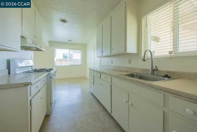 a kitchen with sink and cabinets