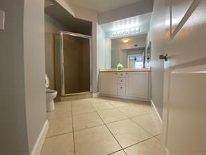 1690 Renaissance Commons Boulevard, Unit 1623 Boynton Beach, FL 33426 - Photo 6 of 9 a bathroom with a mirror and a shower