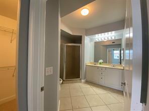1690 Renaissance Commons Boulevard, Unit 1623 Boynton Beach, FL 33426 - Photo 8 of 9 a bathroom with a granite countertop sink mirror and