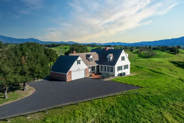 a living room with furniture a fireplace and a wooden floor