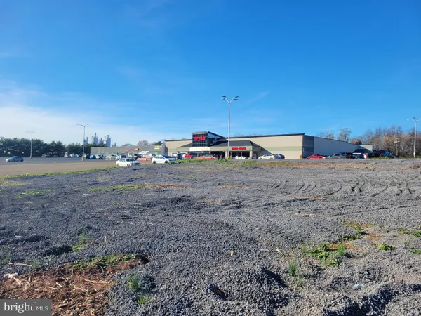 a view of a dirt road with a building